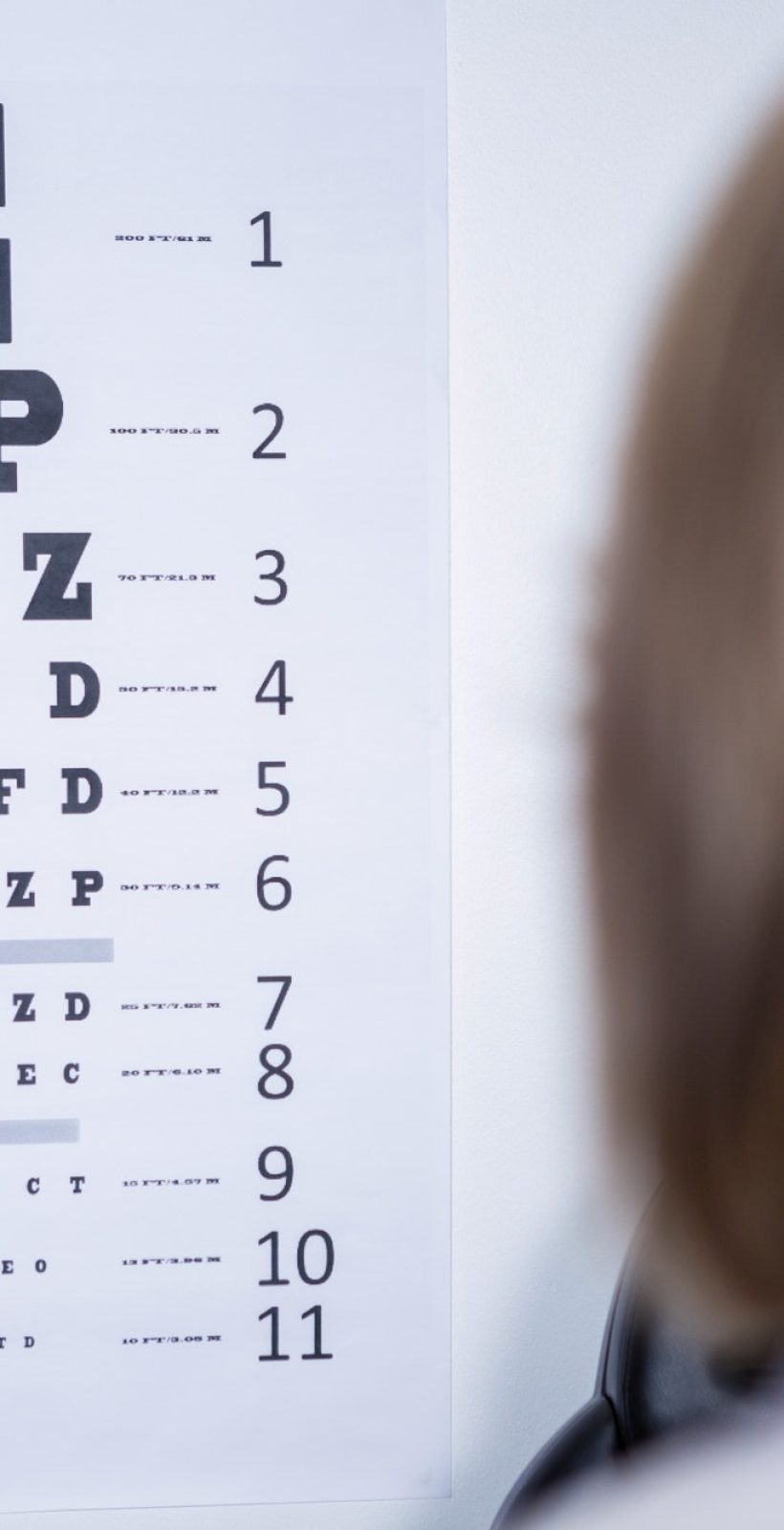 optometrist-looking-at-eye-chart.jpg